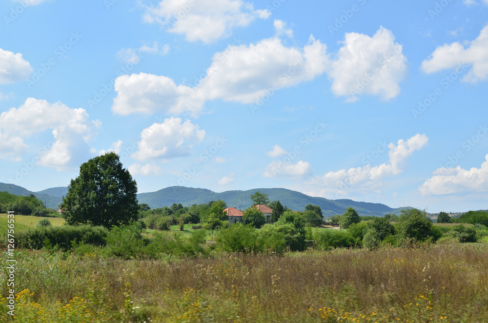 Two old village houses in picturesque landscape in central Serbia