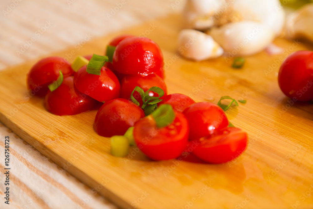 little cocktail tomatoes lies on a board little cocktail tomatoes lies on a board