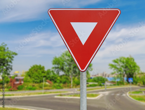 Red triangle road traffic coordination sign on road