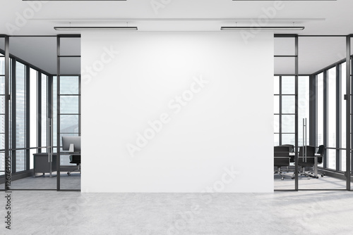 Office lobby with a large white wall and two meeting rooms