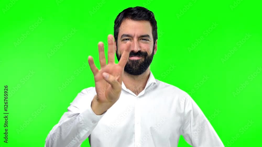 Handsome man counting one to ten on green screen chroma key Handsome man counting one to ten on green screen chroma key