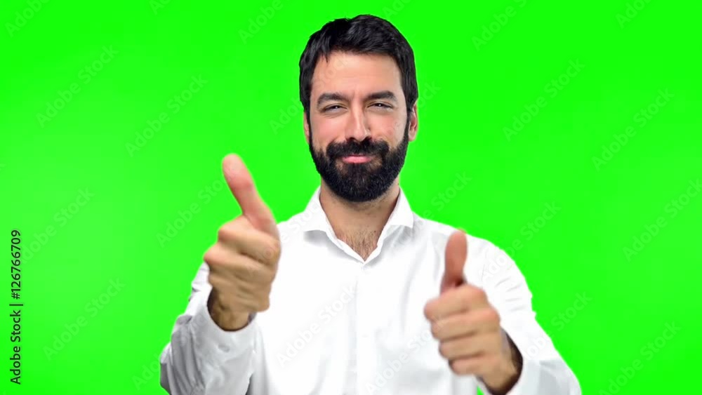 Handsome man with thumb up on green screen chroma key Handsome man with thumb up on green screen chroma key