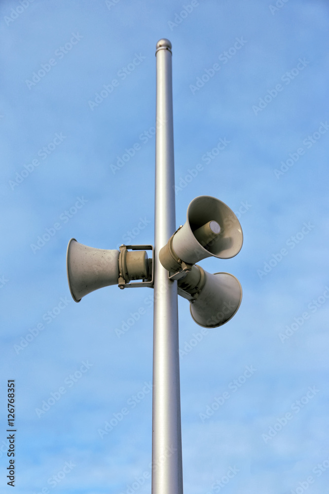 horn speaker with sky in the background.