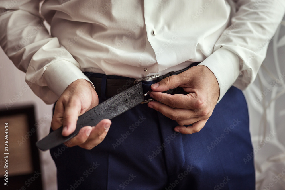 man putting on a belt, Businessman, Politician, man's style, male hands closeup, American businessman, European businessman, a businessman from Asia, People, business, fashion and clothing concept
