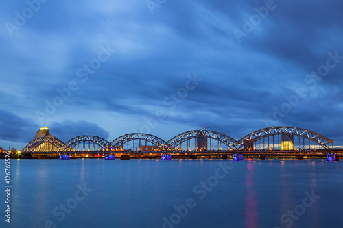 Illuminated railway bridge at night in Riga, Latvia