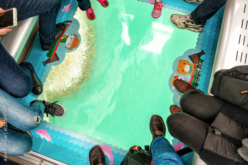 Obraz premium Ocean shore viewed through the transparent glass floor of a Crystal Cabin, Ngong Ping Skyrail on Lantau Island, Hong Kong