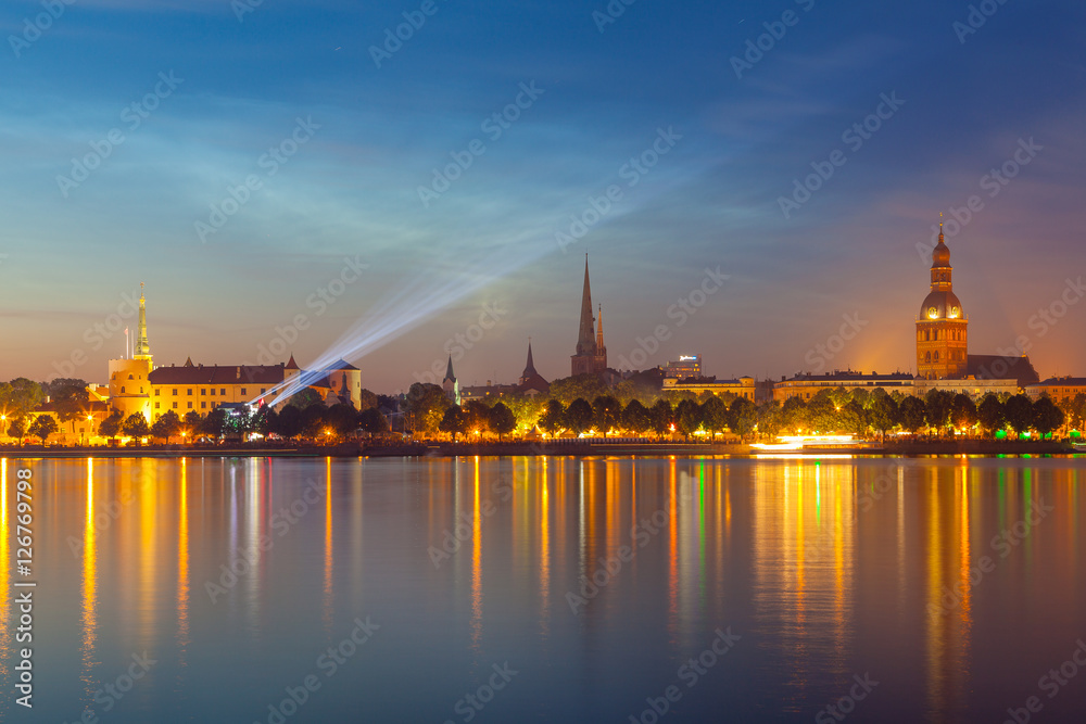 RIGA, LATVIA - 23 JUN 2016. Amazing night panorama of illuminated old town of Riga with reflection in Daugava river. Shortest night in a year, Ligo festival
