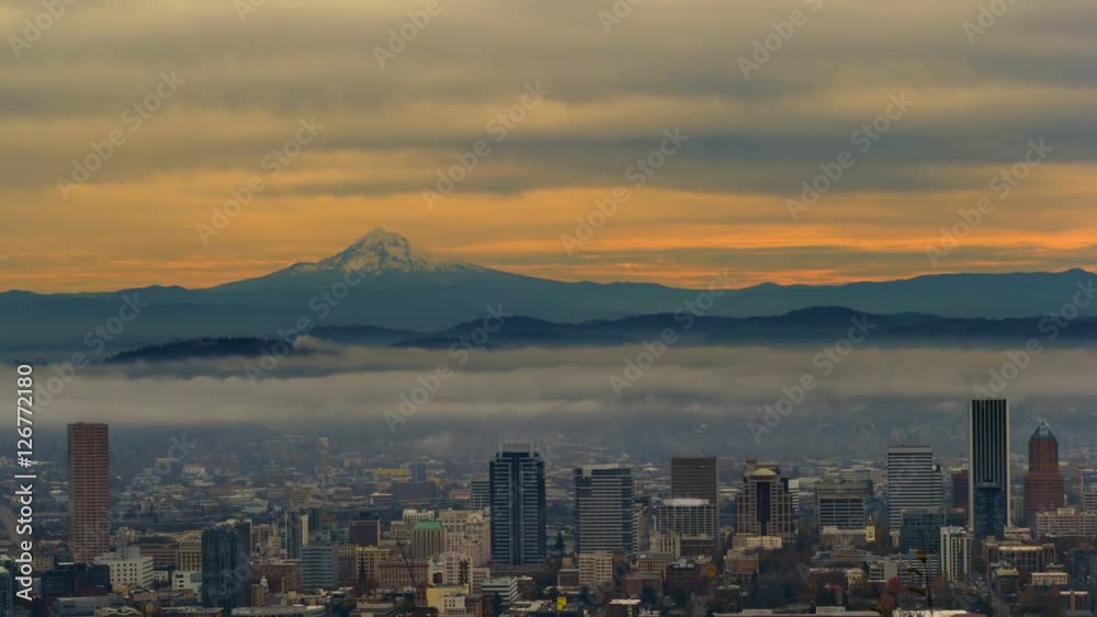 Ultra high definition 4k time lapse movie of moving clouds and low fog over cityscape of downtown Portland Oregon and snow covered mt. hood one early morning at sunrise 4096x2304 uhd