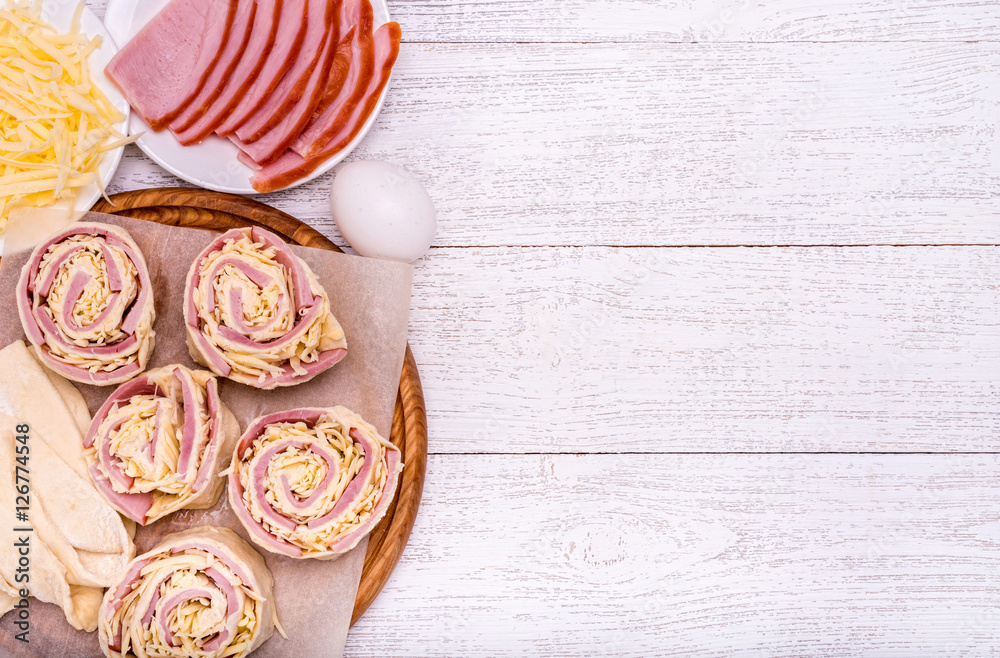Ham and cheese rolls on wooden board. Concept of cooking. Ham and cheese rolls on wooden board. Concept of cooking.