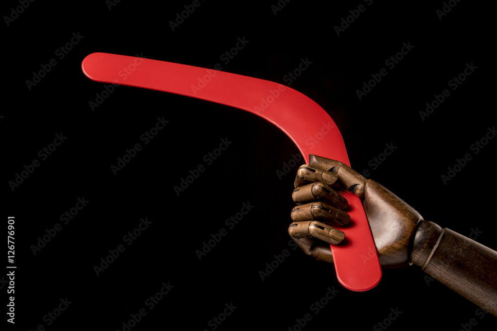 Black man throws a boomerang isolated on white background. With copy space text. Studio shot.