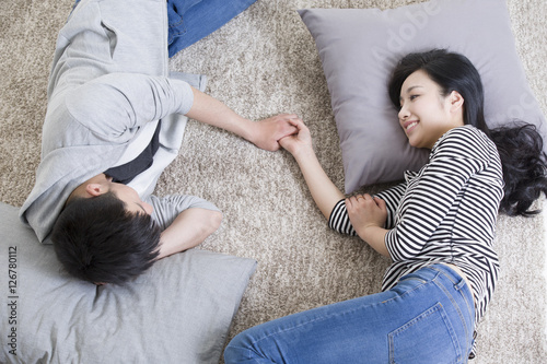 Overhead view of couple lying on carpet