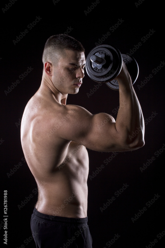 Strong young man showing his muscles 