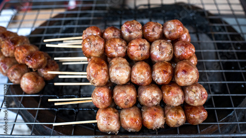 Sausage skewers on the grill grate steel.