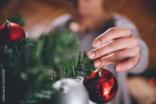 Woman decorating christmas tree