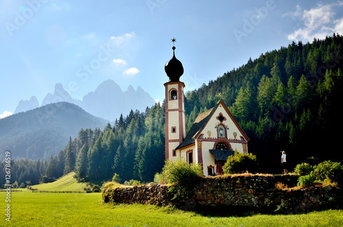 church in the foothills of the Dolomites. Funes Valley, Dolomites, Italy. St John church under autumn sun