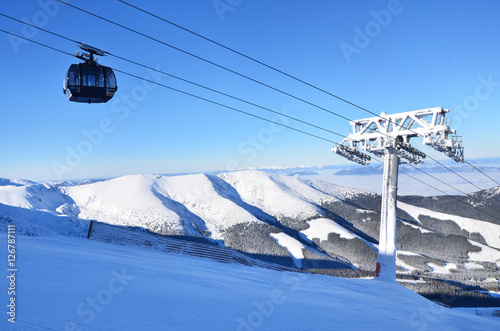 Chairlift over winter landscape in wonderful mountains full of snow