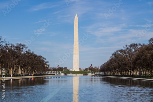 Washington monument in springtime with reflecting pool in the foreground.  
