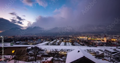 Innsbruck, Austria - view from Bichlweg / Ambraser Castle-Park via Innsbruck on snowy Alps at sunset - Timelapse with pan left to right