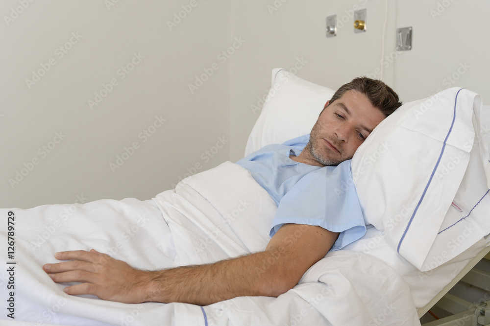 young patient man lying at hospital bed resting tired looking sad and  depressed worried Stock Photo | Adobe Stock