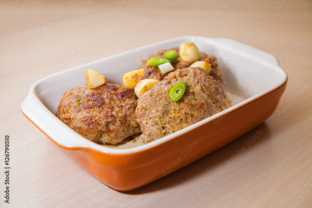 meat burger lies in a baking dish meat burger lies in a baking dish