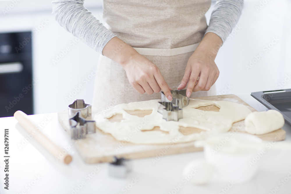 Young woman making cookies in kitchen Young woman making cookies in kitchen