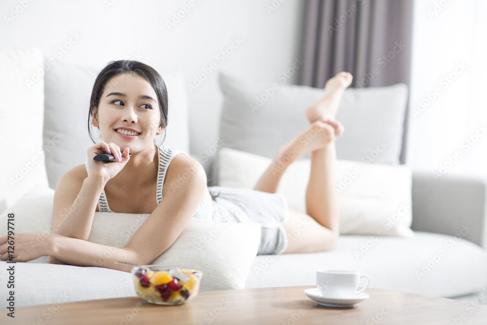 Young woman watching TV at home Young woman watching TV at home