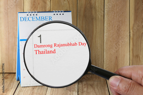 Magnifying glass in hand on calendar you can look text Damrong R photo