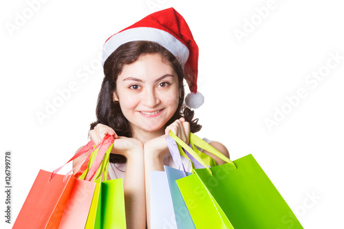 Happy smiling beautiful woman wearing chirstmas hat holding colo