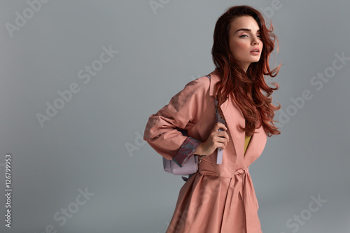 Woman Style. Fashion Model Wearing Fashionable Clothes In Studio