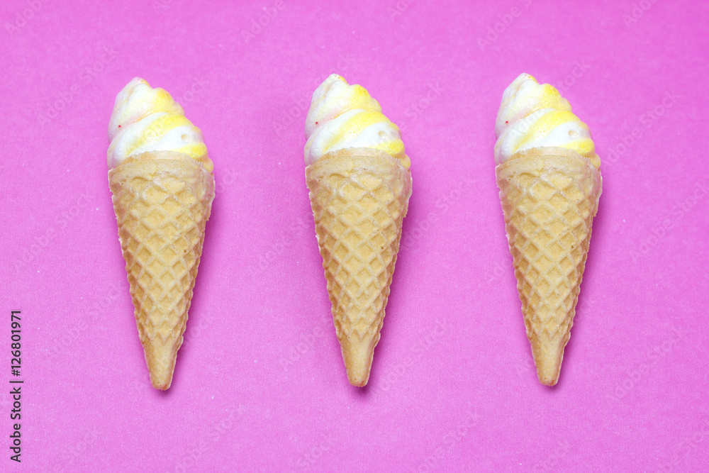 Ice cream waffle cone shape made out of sugar on pink paper, copy space Ice cream waffle cone shape made out of sugar on pink paper, copy space