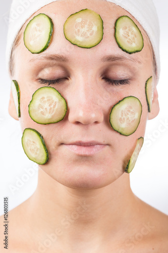 A young girl makes a face mask.