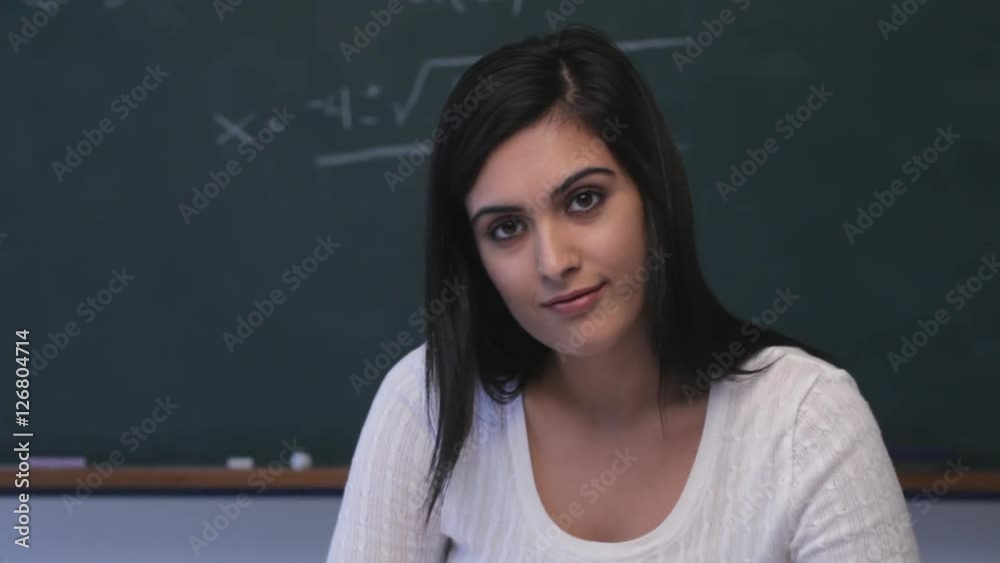 CU Young woman writing at desk in classroom CU Young woman writing at desk in classroom