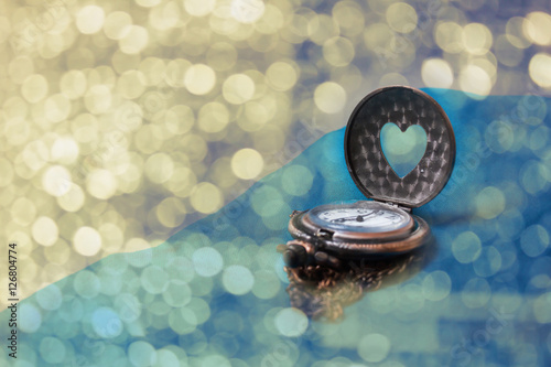 Romantic love bokeh background with heart shape clock photo