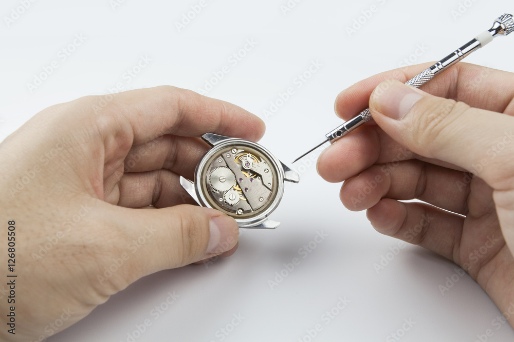 Chinese watchmaker repairing a wristwatch Chinese watchmaker repairing a wristwatch