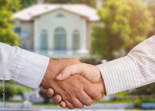 People shaking hands in a real estate transaction photo