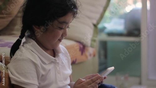 Asian girls playing a game on smart phone