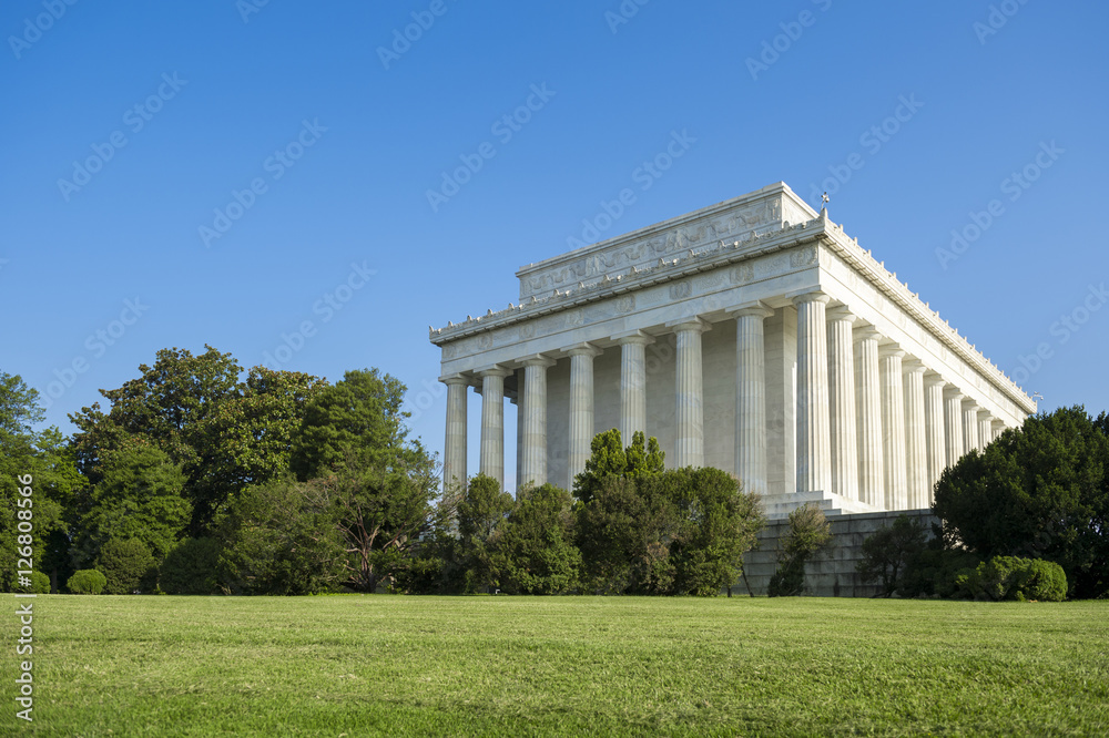 Scenic exterior view of the classical architecture of the Lincoln Memorial in Washington, DC on a bright blue sky summer morning