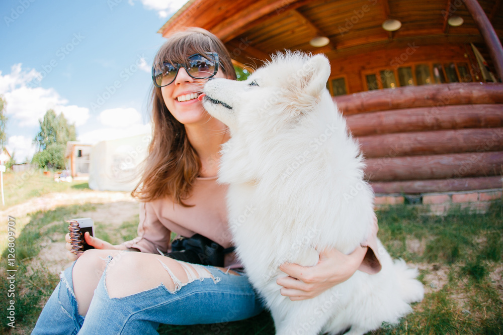 young stylish hipster woman girl playing white kid-skin dog in country side young stylish hipster woman girl playing white kid-skin dog in country side
