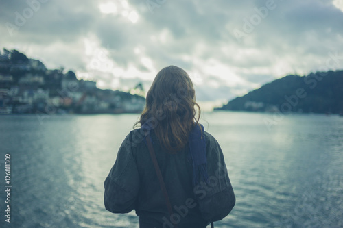 Woman by river in small town