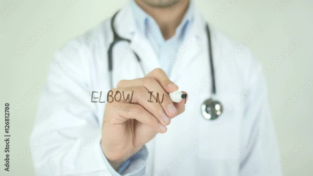 Elbow In Pain , Doctor Writing On Transparent Screen Elbow In Pain , Doctor Writing On Transparent Screen