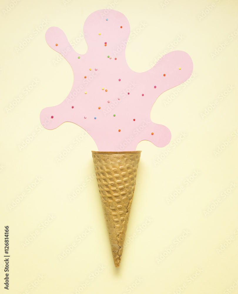 Tasty splash / Creative concept photo of an empty waffle cone with a stain  made of paper on yellow background.