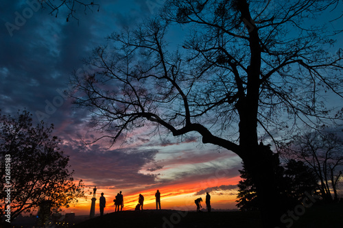Silhouette of a group of people at colorful sunset over Kalemegdan park in Belgrade, Serbia 
