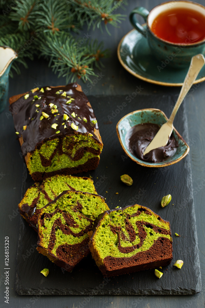 Chocolate pistachio cake with frosting.