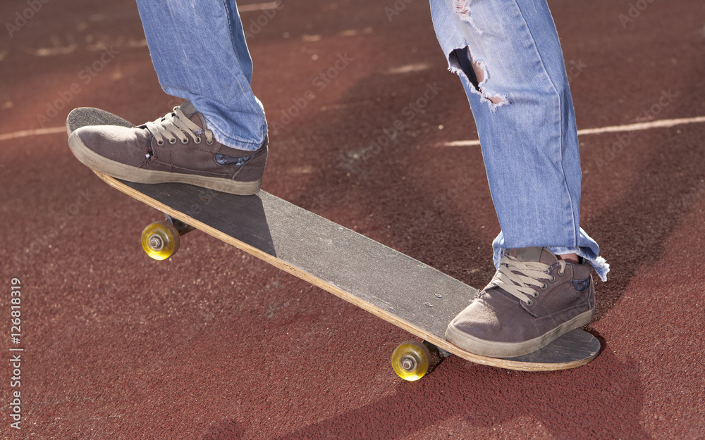 Teenager doing exercises on a skateboard Teenager doing exercises on a skateboard