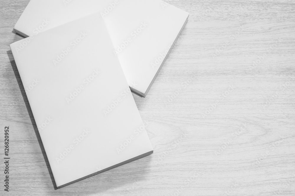 Fototapeta premium Real 3D paperback white books stack on a wood background