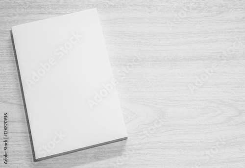 Real 3D paperback white book on a wood background photo