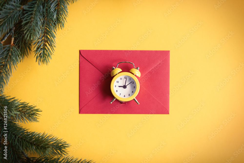 Red christmas envelope and little alarm clock Red christmas envelope and little alarm clock