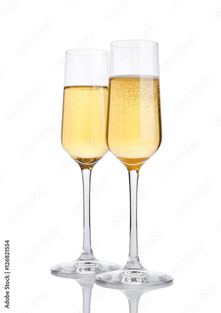 Glasses of champagne with bubbles on white