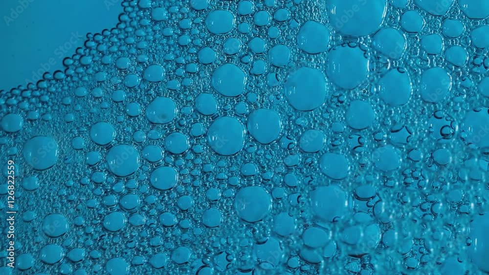 Air bubbles broken on blue background, time lapse. Air bubbles broken on blue background, time lapse.