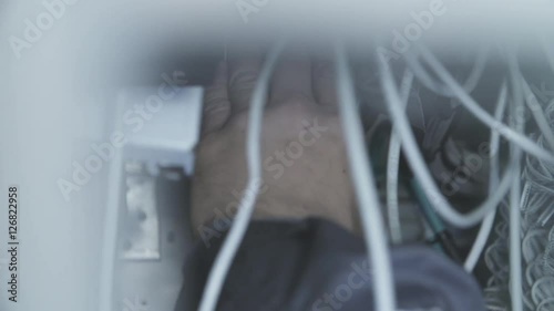 Network lights abstract details.Factory worker connecting electrical wires. Repair man fixing problem with wires or cables. photo